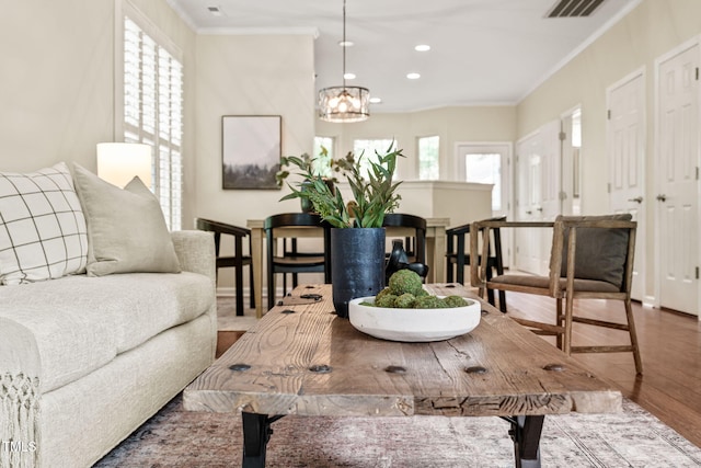 dining space featuring crown molding, wood finished floors, a chandelier, recessed lighting, and baseboards