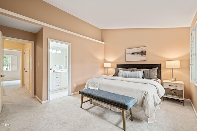 bedroom featuring carpet flooring, baseboards, connected bathroom, and vaulted ceiling