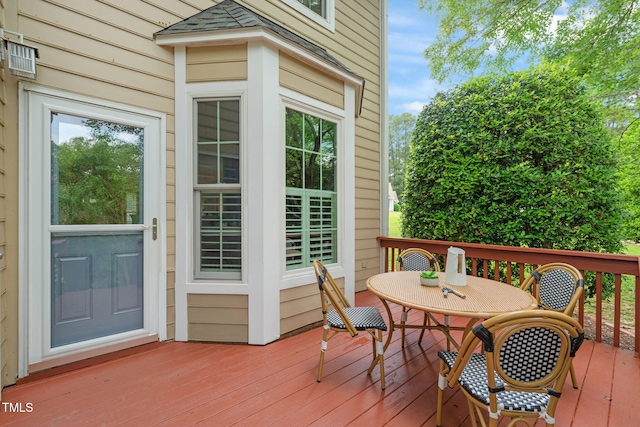 wooden deck with outdoor dining space