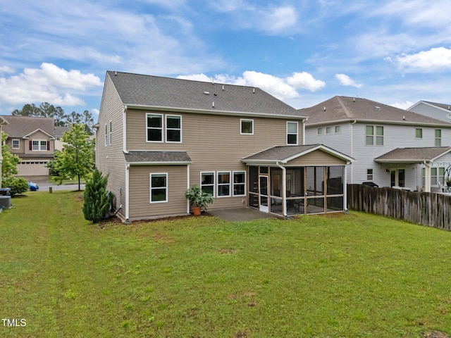 back of house featuring a sunroom and a residential view