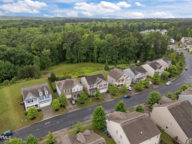 aerial perspective of suburban area featuring a forest