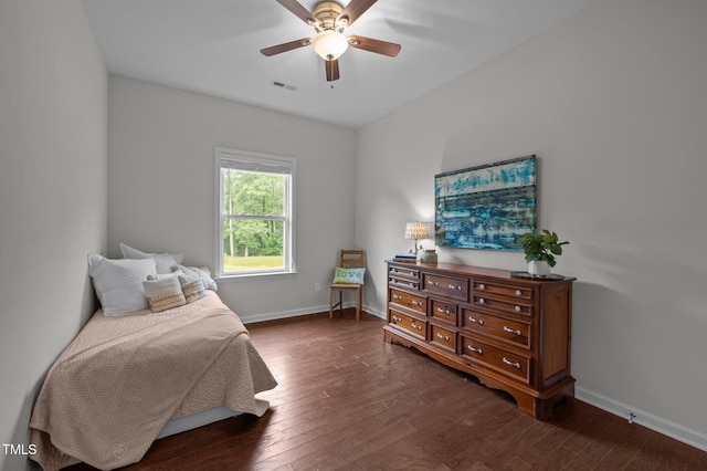bedroom featuring dark wood finished floors, baseboards, and a ceiling fan