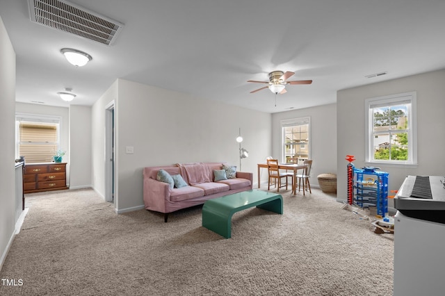 living area with carpet floors and ceiling fan