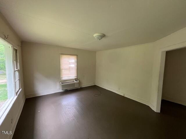 246 Keene St, Henderson, NC 27536 - spare room with plenty of natural light, a wall unit AC, and baseboards