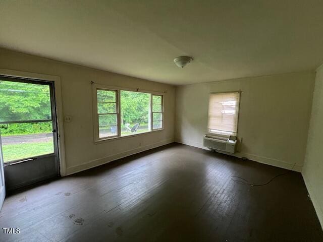 246 Keene St, Henderson, NC 27536 - empty room featuring hardwood / wood-style floors, baseboards, and a wall mounted air conditioner
