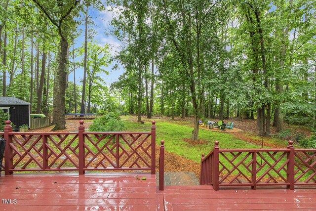wooden terrace with view of wooded area