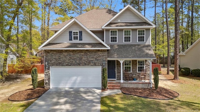 116 Argyll Ave, Aberdeen, NC 28315 - craftsman-style house with stone siding, covered porch, roof with shingles, concrete driveway, and an attached garage