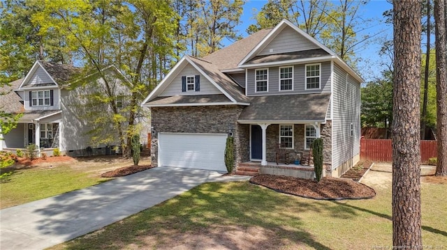 116 Argyll Ave, Aberdeen, NC 28315 - view of front of property with a porch, driveway, stone siding, an attached garage, and a shingled roof