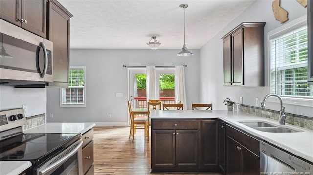 116 Argyll Ave, Aberdeen, NC 28315 - kitchen featuring stainless steel appliances, a sink, light wood-style flooring, and plenty of natural light