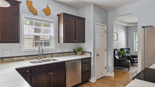 116 Argyll Ave, Aberdeen, NC 28315 - kitchen with stainless steel appliances, a sink, light wood-type flooring, light countertops, and dark brown cabinetry