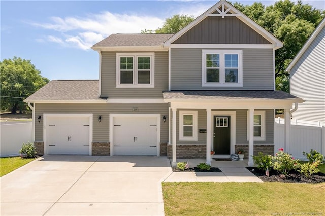 craftsman inspired home with concrete driveway, covered porch, board and batten siding, a shingled roof, and an attached garage