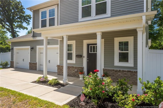 view of front of house featuring a garage, brick siding, fence, and concrete driveway