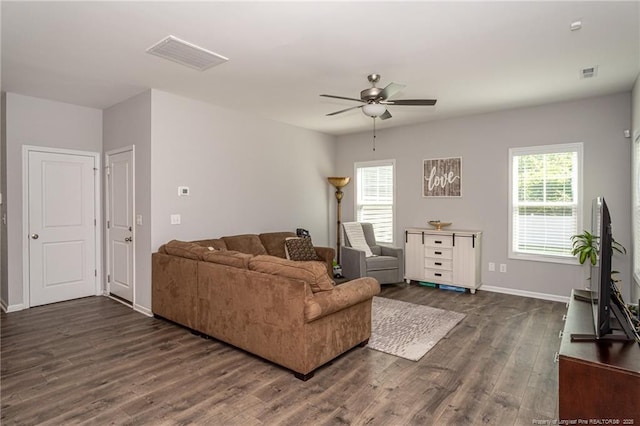living room with ceiling fan, dark wood-style flooring, and baseboards
