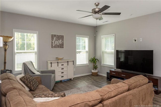 living area featuring wood finished floors, a ceiling fan, plenty of natural light, and baseboards