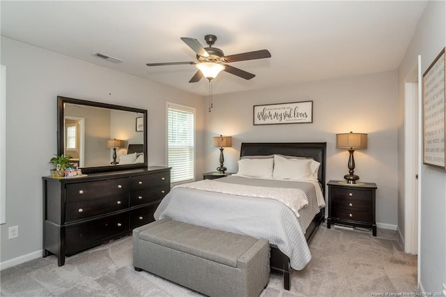 carpeted bedroom featuring baseboards and a ceiling fan