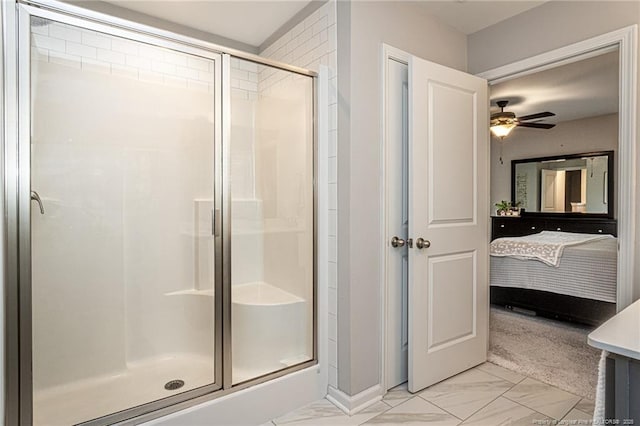 full bath featuring a stall shower, marble look tile flooring, a ceiling fan, and ensuite bathroom