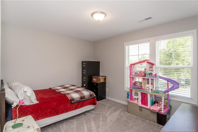 bedroom with multiple windows, carpet, and baseboards