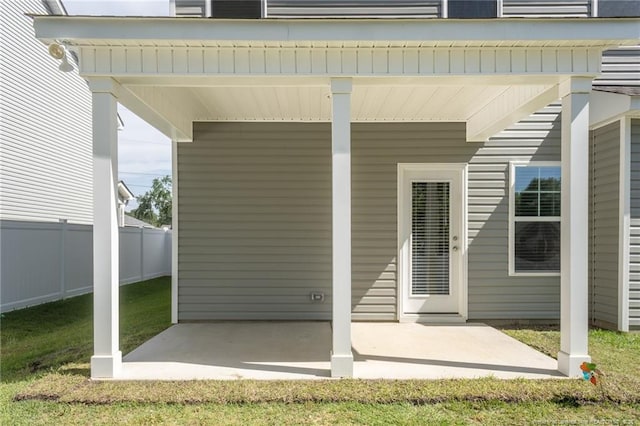 doorway to property featuring fence and a patio