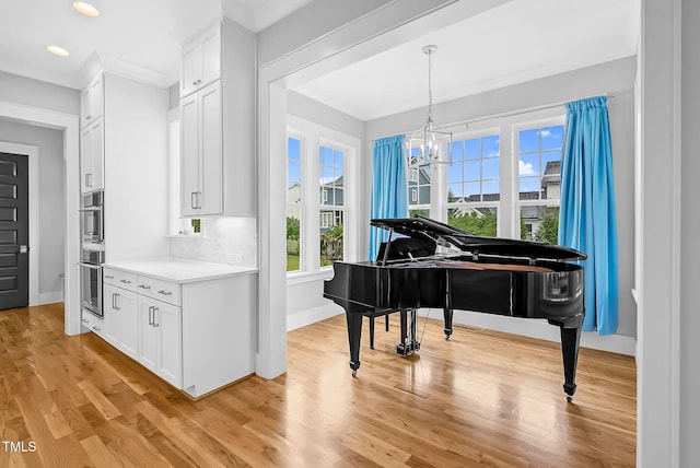 sitting room with recessed lighting, light wood-style flooring, baseboards, and a chandelier