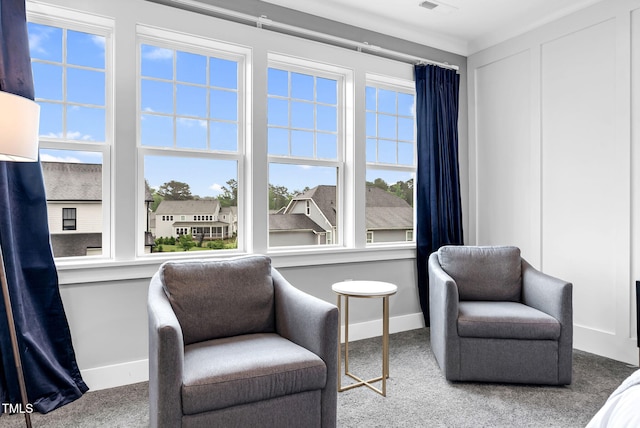 sitting room with baseboards, plenty of natural light, and carpet flooring