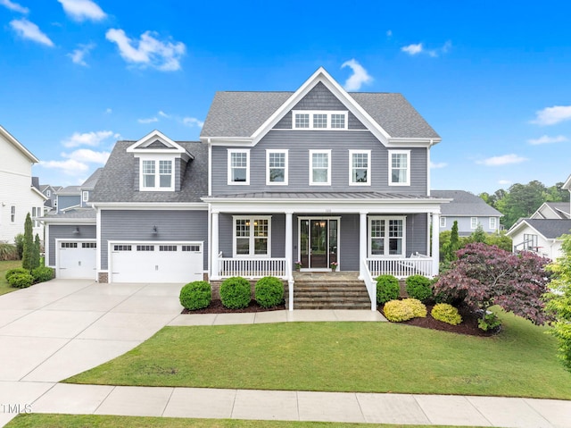 view of front of house with covered porch, concrete driveway, a front lawn, and a garage