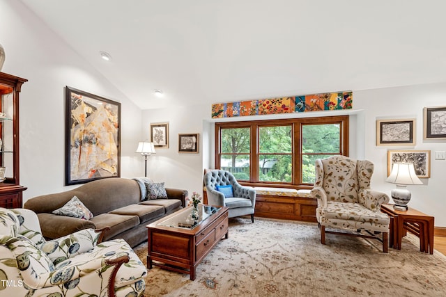 living room featuring lofted ceiling and wood finished floors
