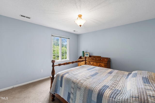 carpeted bedroom featuring baseboards and a textured ceiling