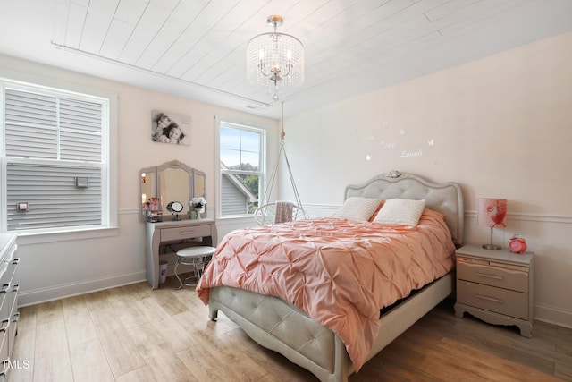 13 Nettletree Creek Ct, Youngsville, NC 27596 - bedroom featuring a chandelier, wood finished floors, baseboards, and wood ceiling