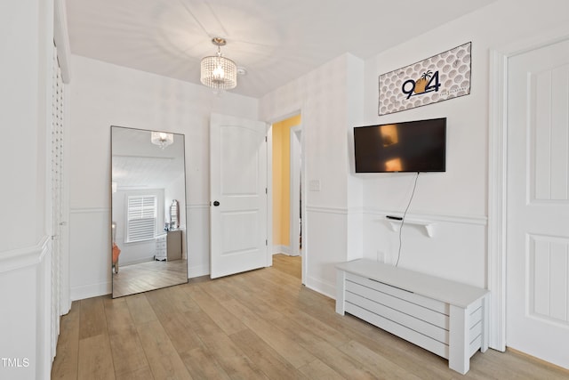 13 Nettletree Creek Ct, Youngsville, NC 27596 - unfurnished bedroom featuring a chandelier and light wood-style floors
