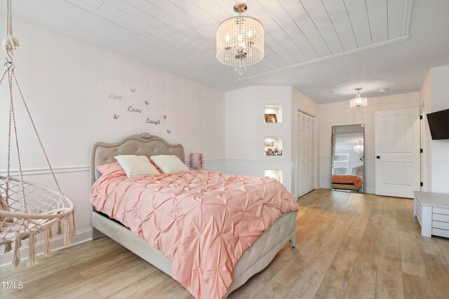 13 Nettletree Creek Ct, Youngsville, NC 27596 - bedroom featuring light wood-style floors, a chandelier, and wood ceiling