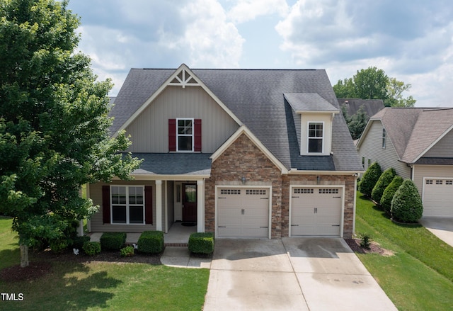 13 Nettletree Creek Ct, Youngsville, NC 27596 - craftsman house featuring concrete driveway, stone siding, a porch, and a front yard
