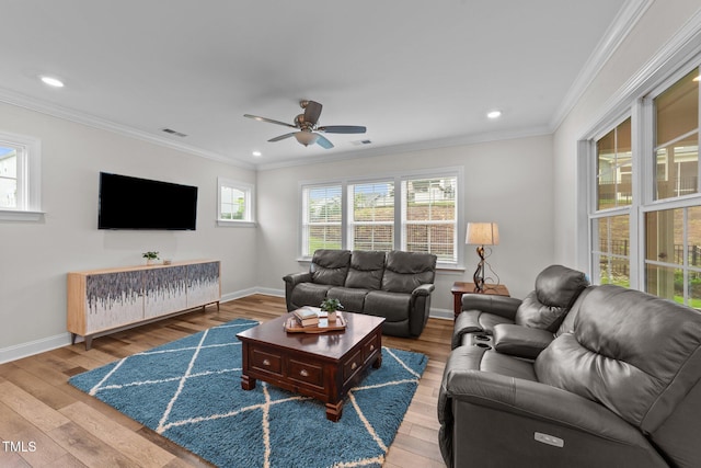 living area featuring wood-type flooring, ceiling fan, ornamental molding, baseboards, and recessed lighting