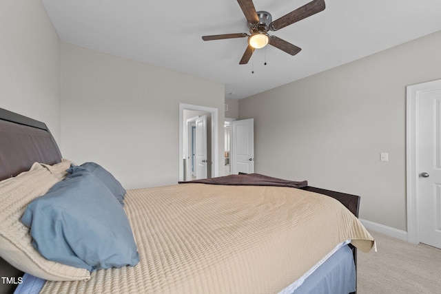 bedroom with light colored carpet, a ceiling fan, and baseboards