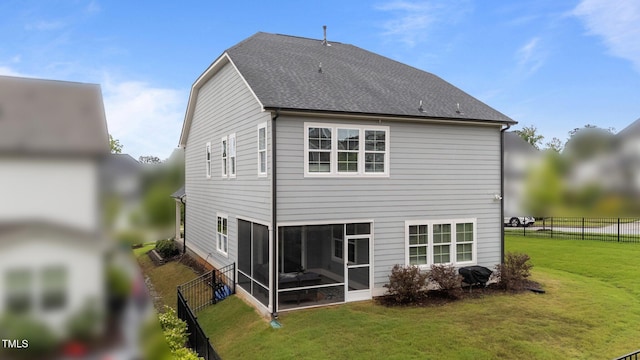 rear view of property with a sunroom and roof with shingles