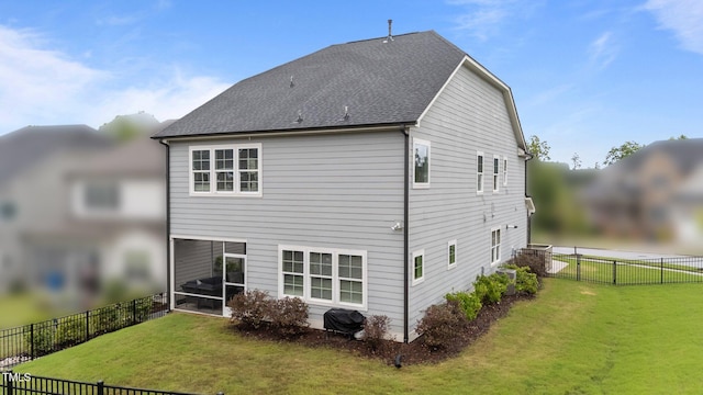 rear view of house featuring a shingled roof