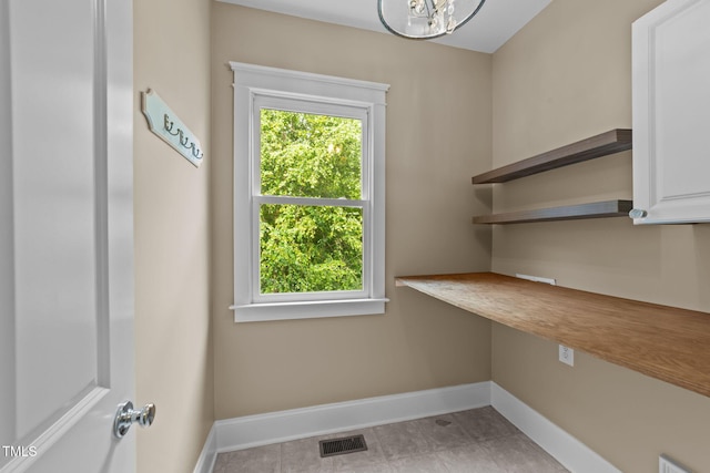 436 Edgepine Dr, Holly Springs, NC 27540 - laundry room featuring baseboards and a chandelier