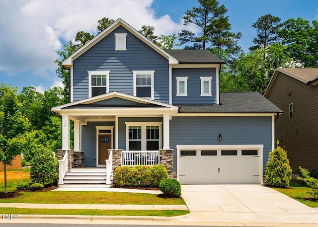 152 Chauncey Cir, Chapel Hill, NC 27516 - view of front facade featuring covered porch, driveway, roof with shingles, and stone siding