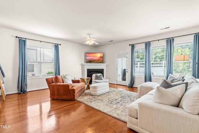 2635 Asher View Ct, Raleigh, NC 27606 - living area with light wood-type flooring, ceiling fan, a fireplace, and baseboards