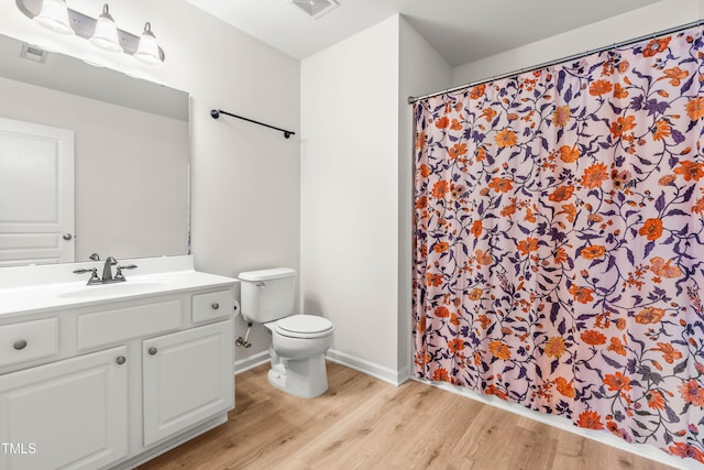 2635 Asher View Ct, Raleigh, NC 27606 - bathroom featuring wood finished floors, toilet, vanity, a shower with curtain, and baseboards