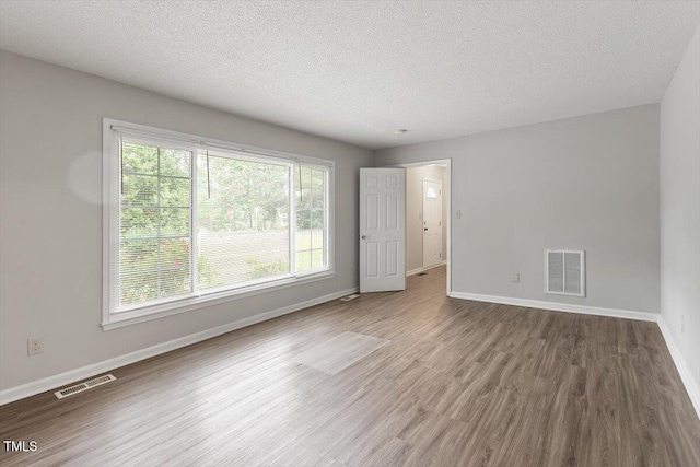 4812 Kaplan Dr, Raleigh, NC 27606 - unfurnished room with wood finished floors, baseboards, and a textured ceiling