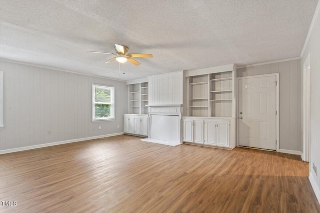 4812 Kaplan Dr, Raleigh, NC 27606 - unfurnished bedroom with light wood-style flooring, a textured ceiling, ornamental molding, ceiling fan, and baseboards