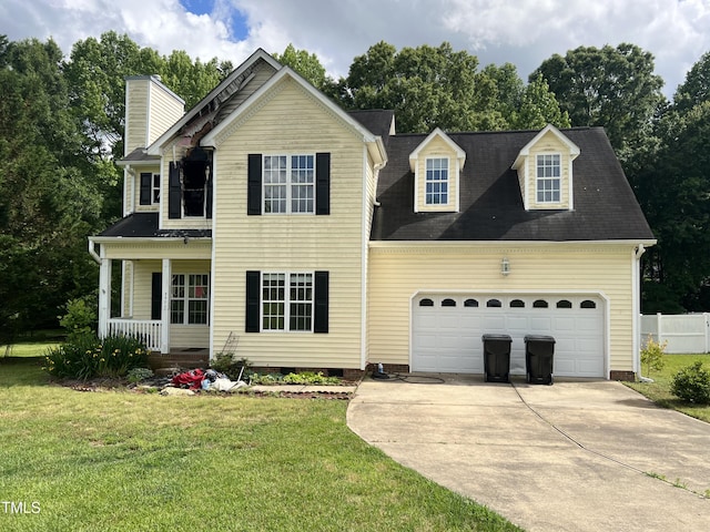2377 Vinson Rd, Clayton, NC 27527 - traditional home with covered porch, driveway, a front lawn, a garage, and a chimney