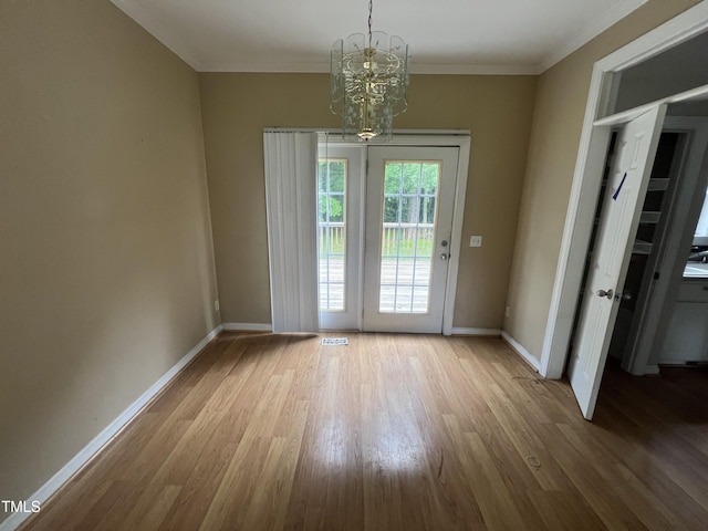 2377 Vinson Rd, Clayton, NC 27527 - unfurnished dining area featuring wood finished floors, a chandelier, baseboards, and crown molding