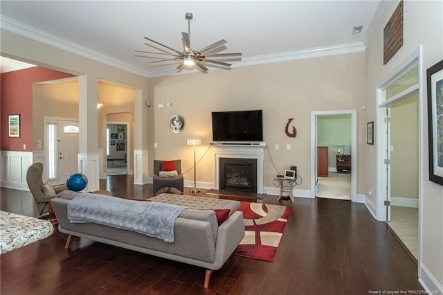 4222 Dock View Rd, Fayetteville, NC 28306 - living room with crown molding, ceiling fan, wood finished floors, a fireplace with flush hearth, and arched walkways