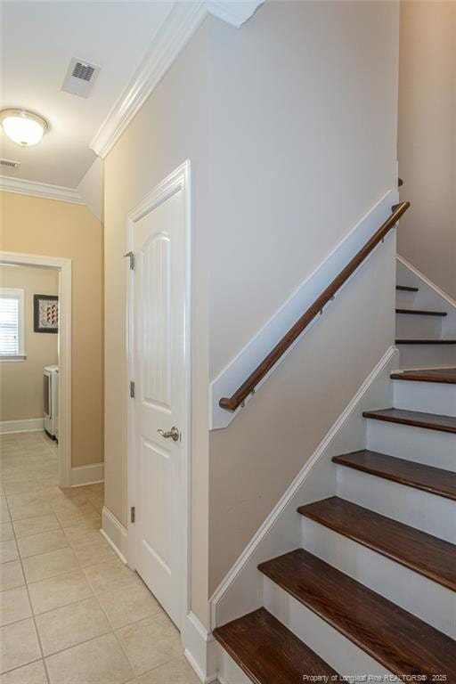 4222 Dock View Rd, Fayetteville, NC 28306 - staircase featuring crown molding, tile patterned flooring, and washer / dryer