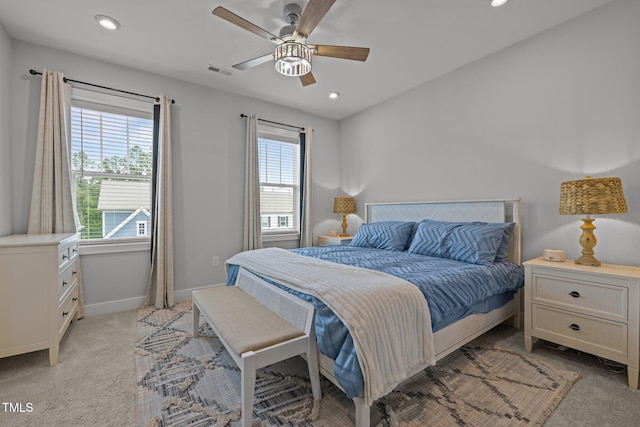 bedroom with light colored carpet, baseboards, recessed lighting, and ceiling fan
