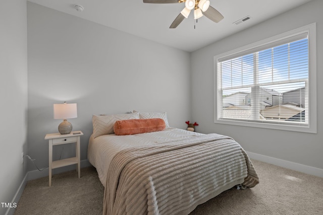 carpeted bedroom featuring baseboards and ceiling fan