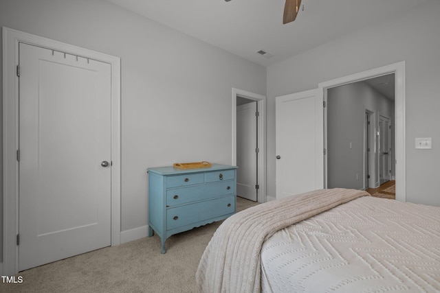 bedroom with light carpet, ceiling fan, and baseboards