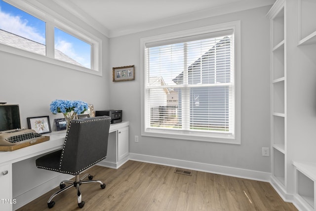 office space with light wood-style flooring and baseboards