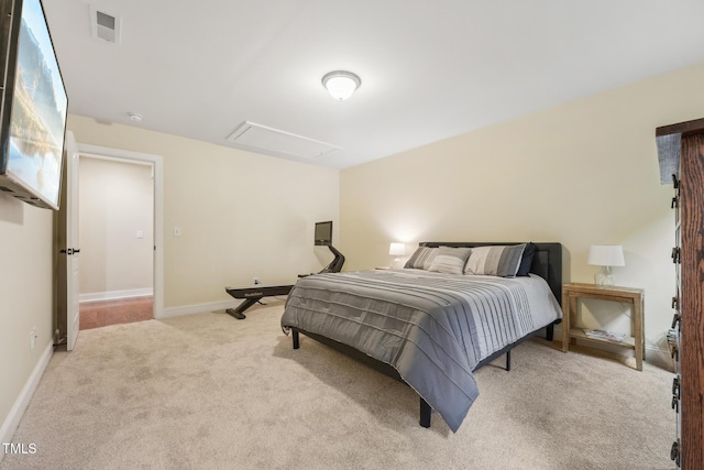 carpeted bedroom featuring baseboards and attic access